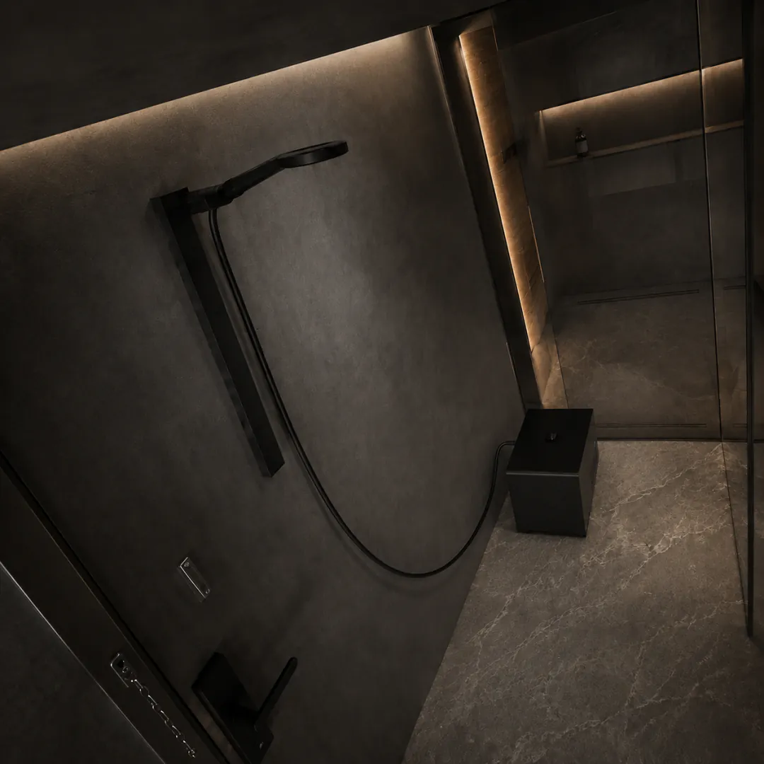 Compact Olsek Ice Shower installed in a dark stone bathroom without a plunge tub