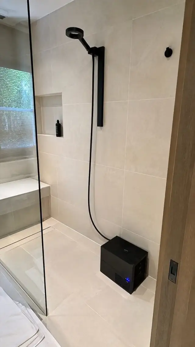Olsek Ice Shower installed in a compact bathroom