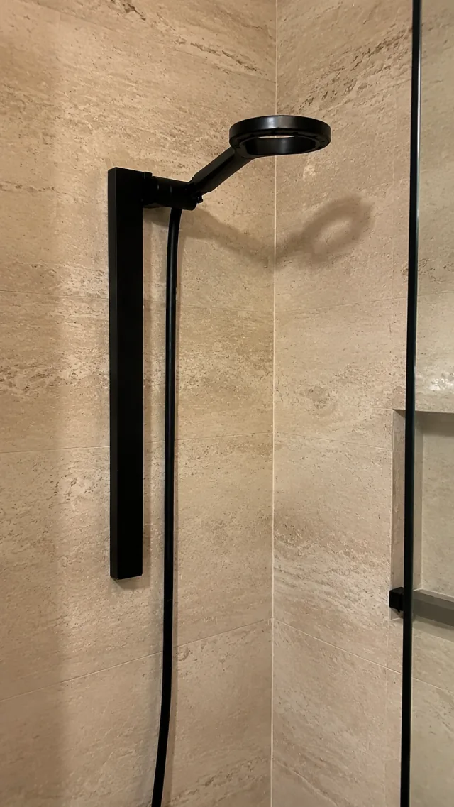 Olsek Halo installed in Maya K.'s beige tiled shower